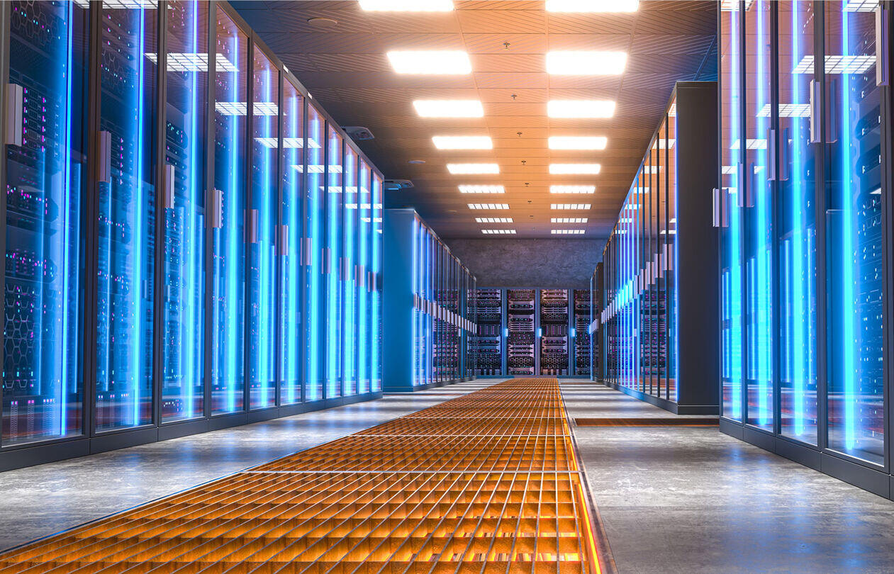 bootloaders_optimized_300 A modern data center with rows of servers illuminated by blue lights, featuring a metallic grid floor and bright overhead lighting.
