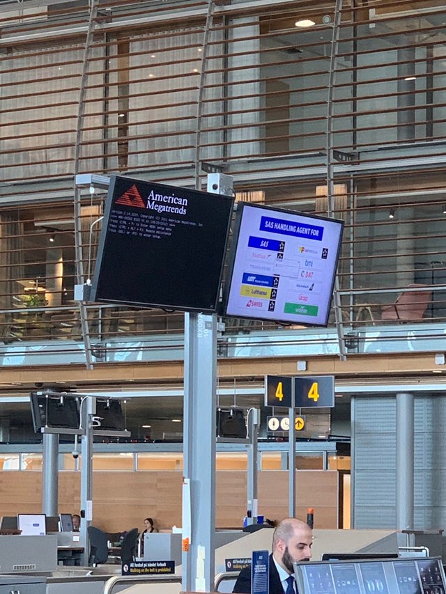 a person standing in front of a large screen