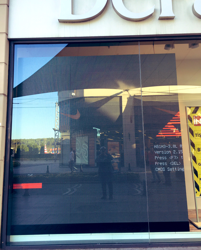 a window with a reflection of a person walking in it